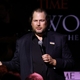 Salesforce co-CEO Marc Benioff holds a microphone up to his mouth as he speaks.